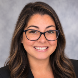 Jennifer’s headshot with a mottled gray backdrop
